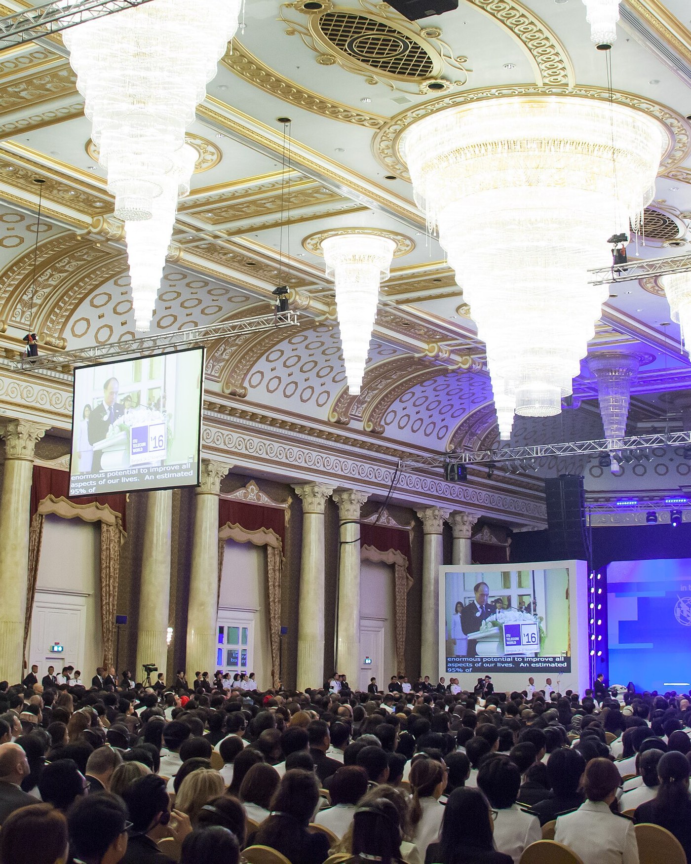 A full house of delegates in a chandelier-lit ballroom at an international conference in Asia